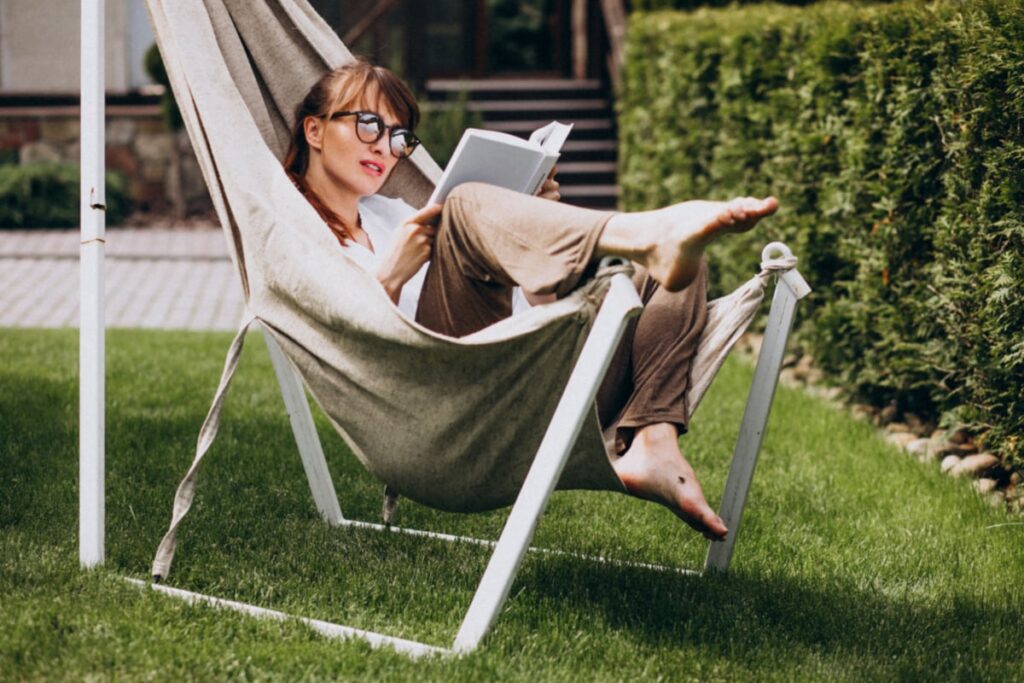 woman-reading-book-garden-by-house