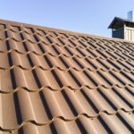 Closeup of house roof top covered with metallic shingles