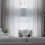 Living luminos amenajat cu canapea deschisă la culoare, covor, plante și mobilier din lemn